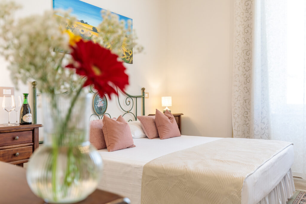 Letto matrimoniale dell'Ampia Camera Matrimoniale di Villa Fontis Rapolano a Rapolano Terme con ambiente luminoso e accogliente.