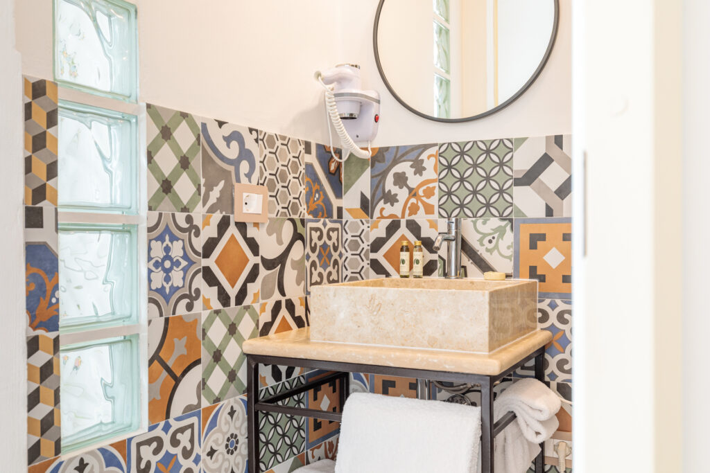 Bagno privato della Camera Matrimoniale Deluxe di Villa Fontis Rapolano con lavabo in pietra naturale e rivestimenti decorativi.